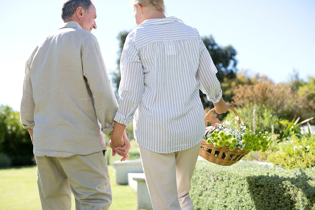 Senior couple holding hands in garden