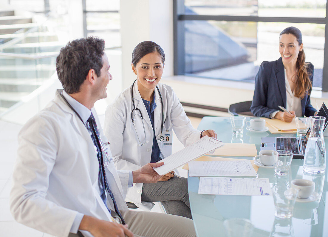 Doctors and businesswoman talking