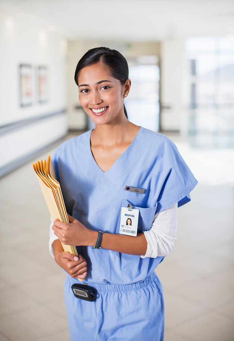 Smiling nurse with folders