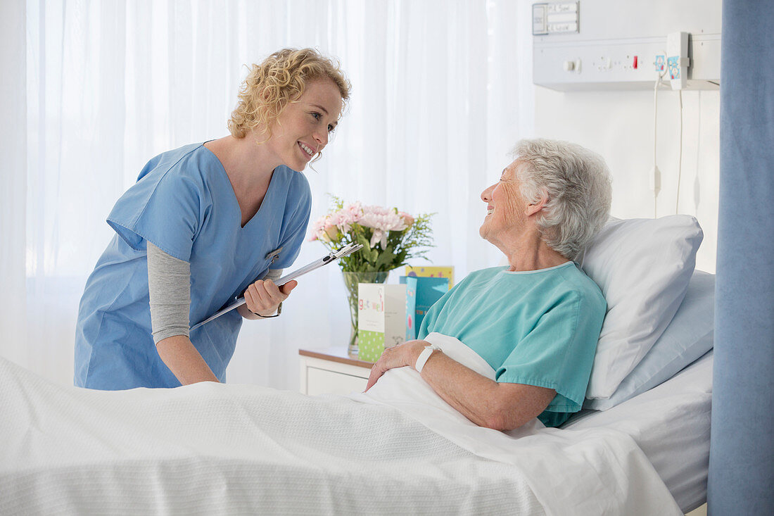 Nurse and aging patient talking room
