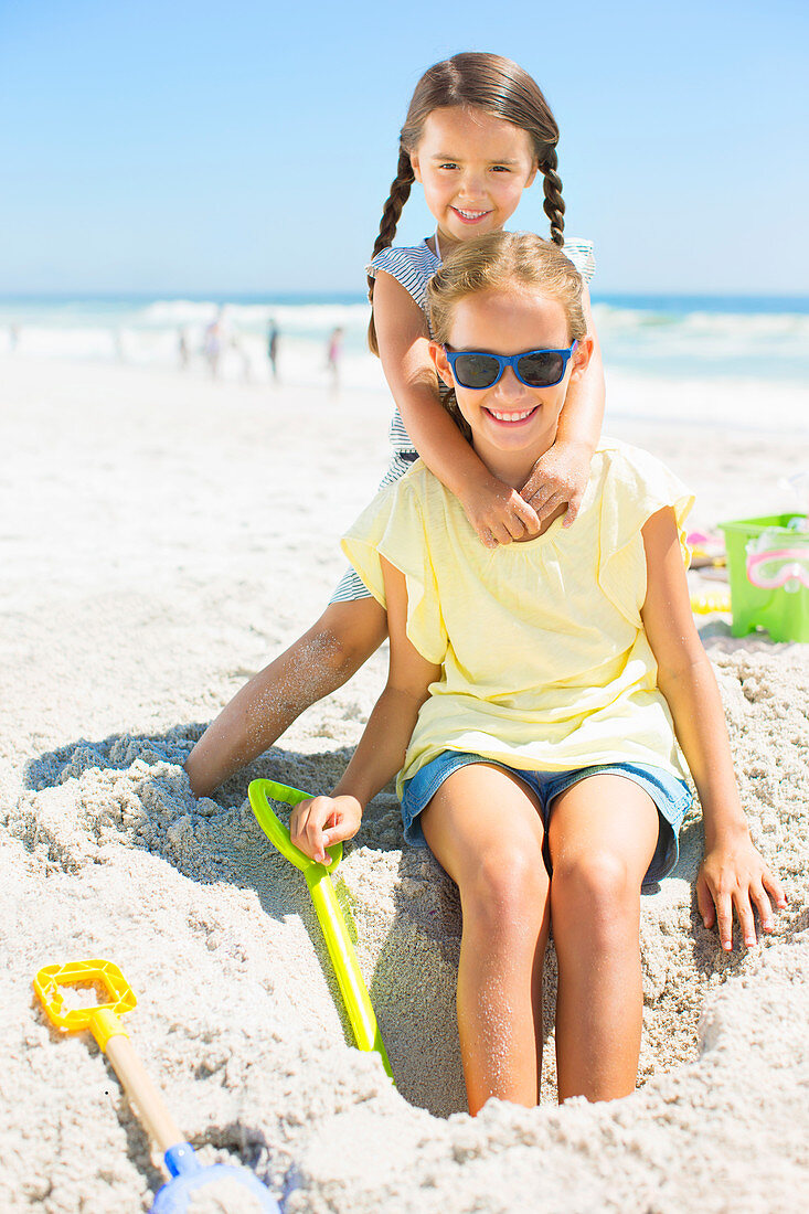 Girls playing in sand at beach