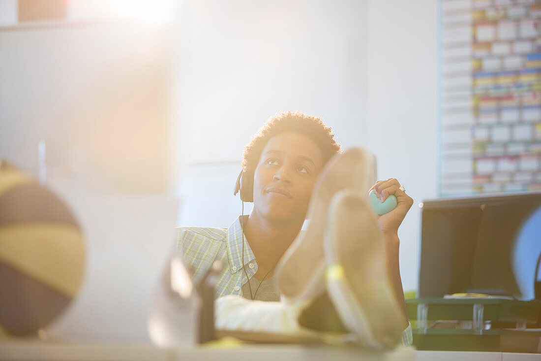 Businessman relaxing at desk in office