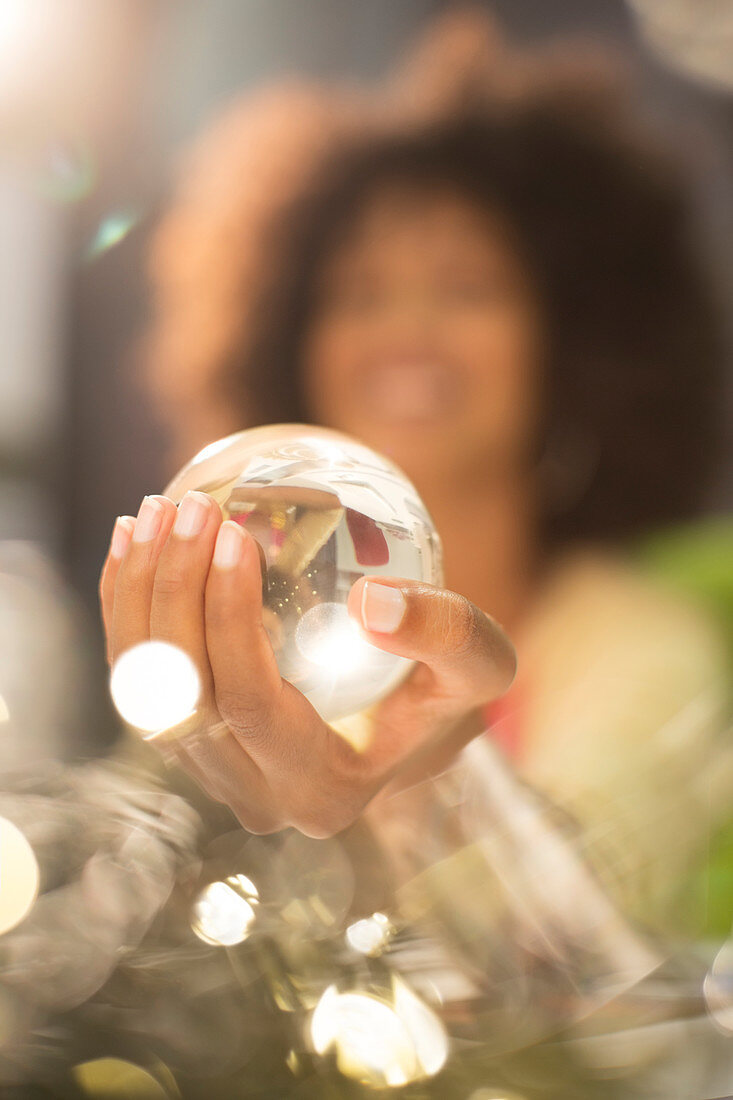 Close up of woman holding crystal ball