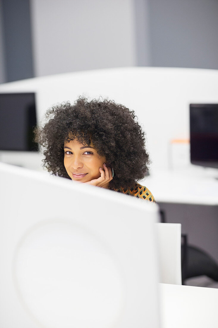 Businesswoman smiling at desk in office