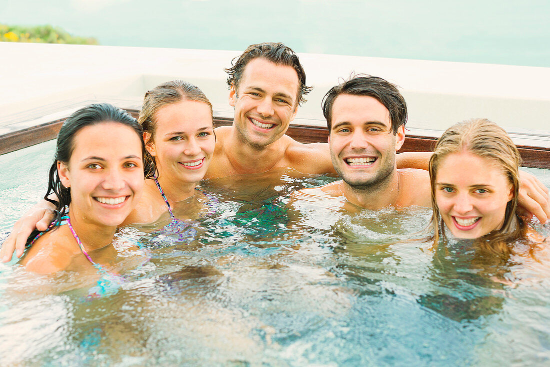 Friends smiling together in hot tub