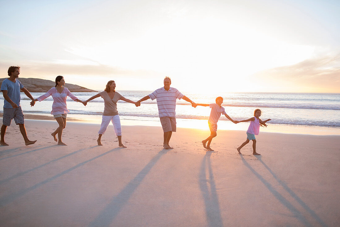 Family holding hands on beach