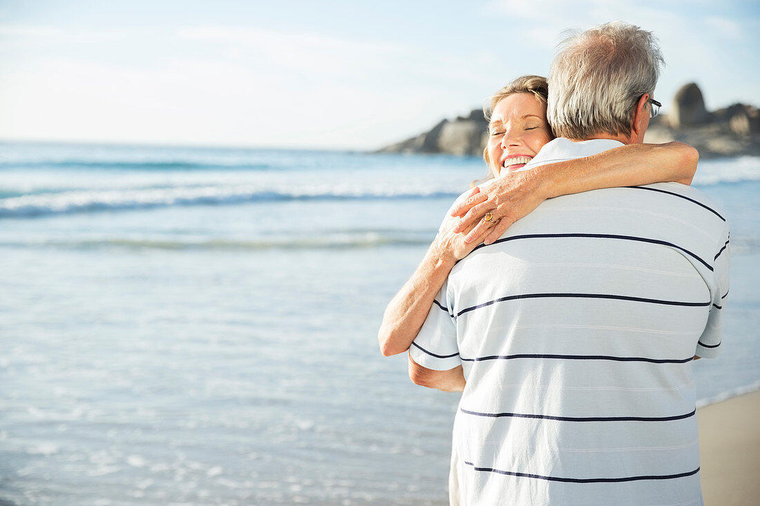 Senior couple hugging on beach