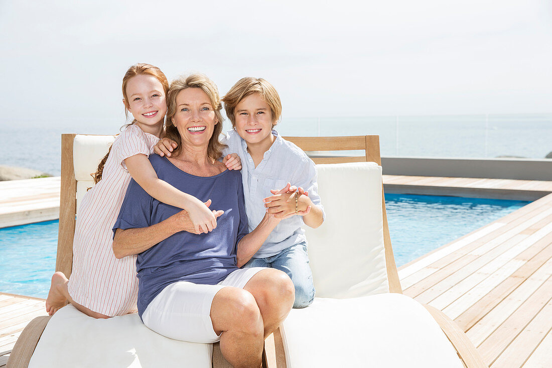 Grandmother and grandchildren at poolside