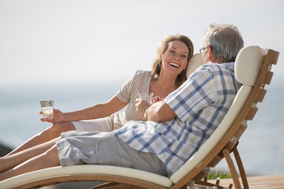 Older couple relaxing in lawn chairs