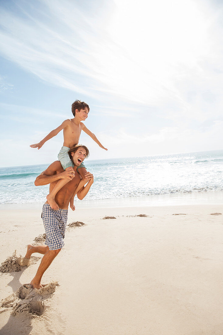 Father and son playing on beach