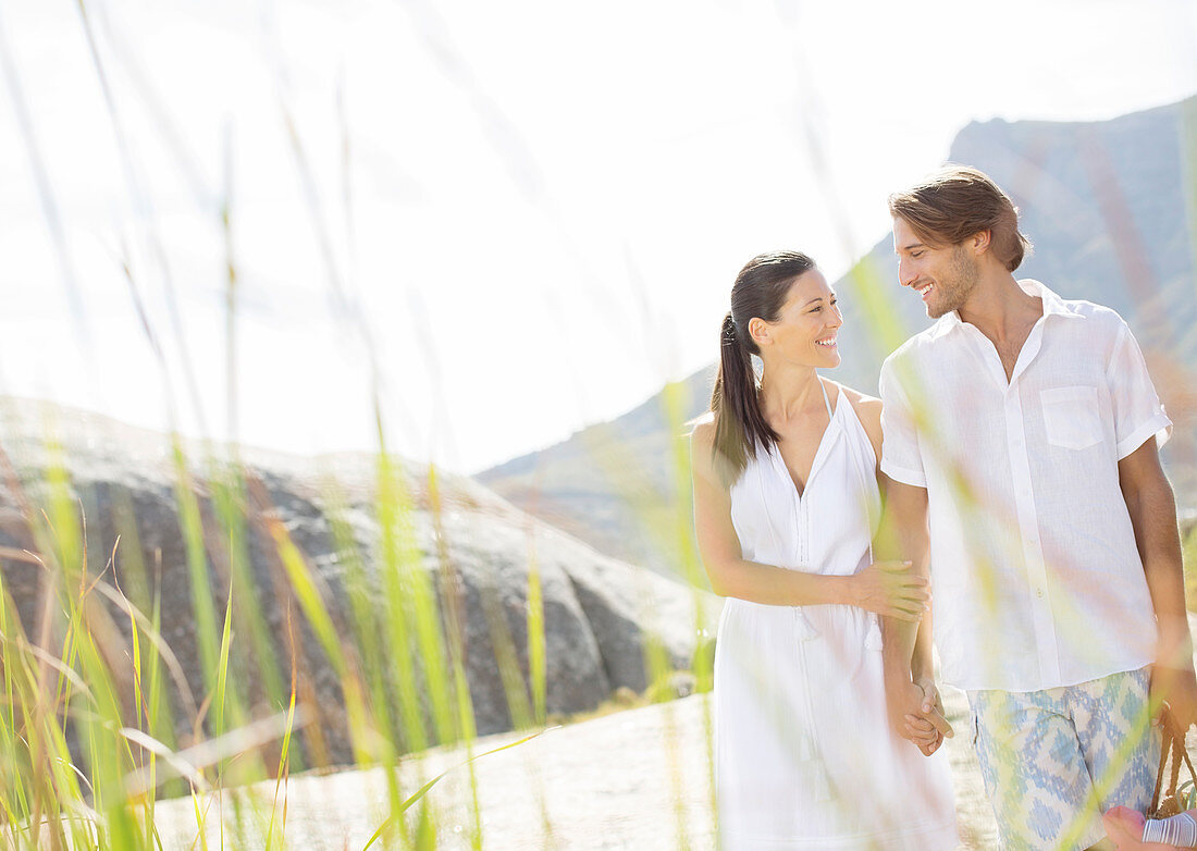 Couple walking together by beach