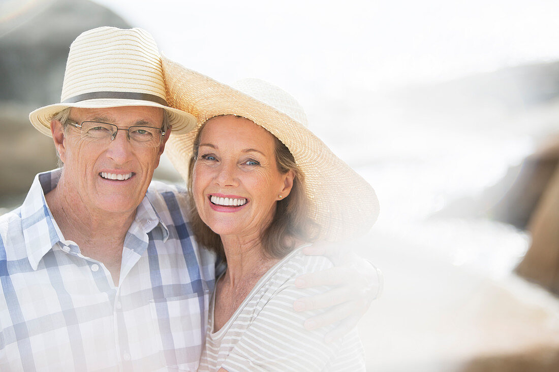 Older couple smiling on beach