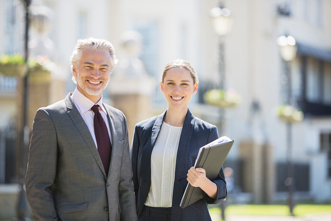 Business people smiling outdoors