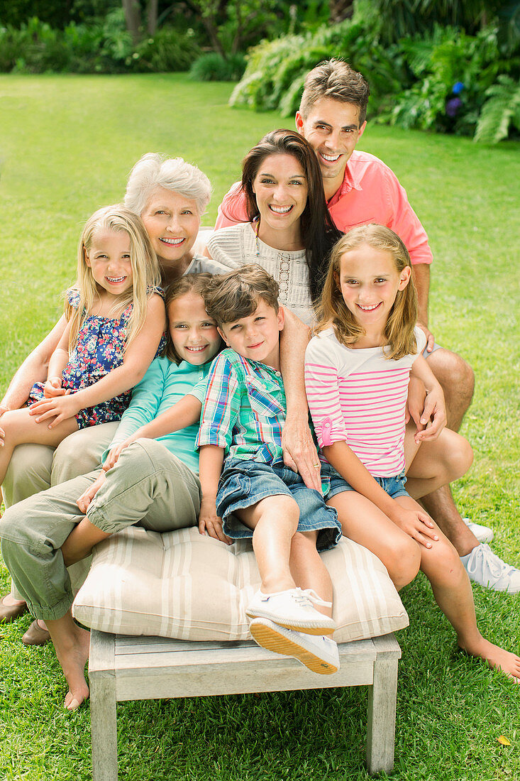 Family sitting together in backyard