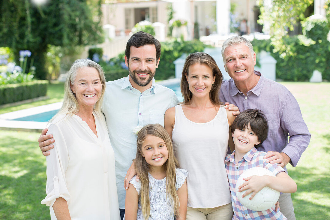 Family smiling in backyard