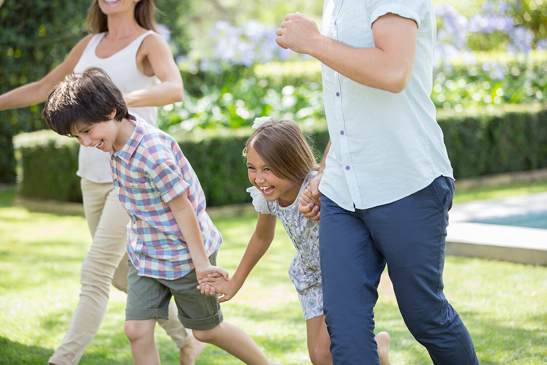 Family holding hands and running