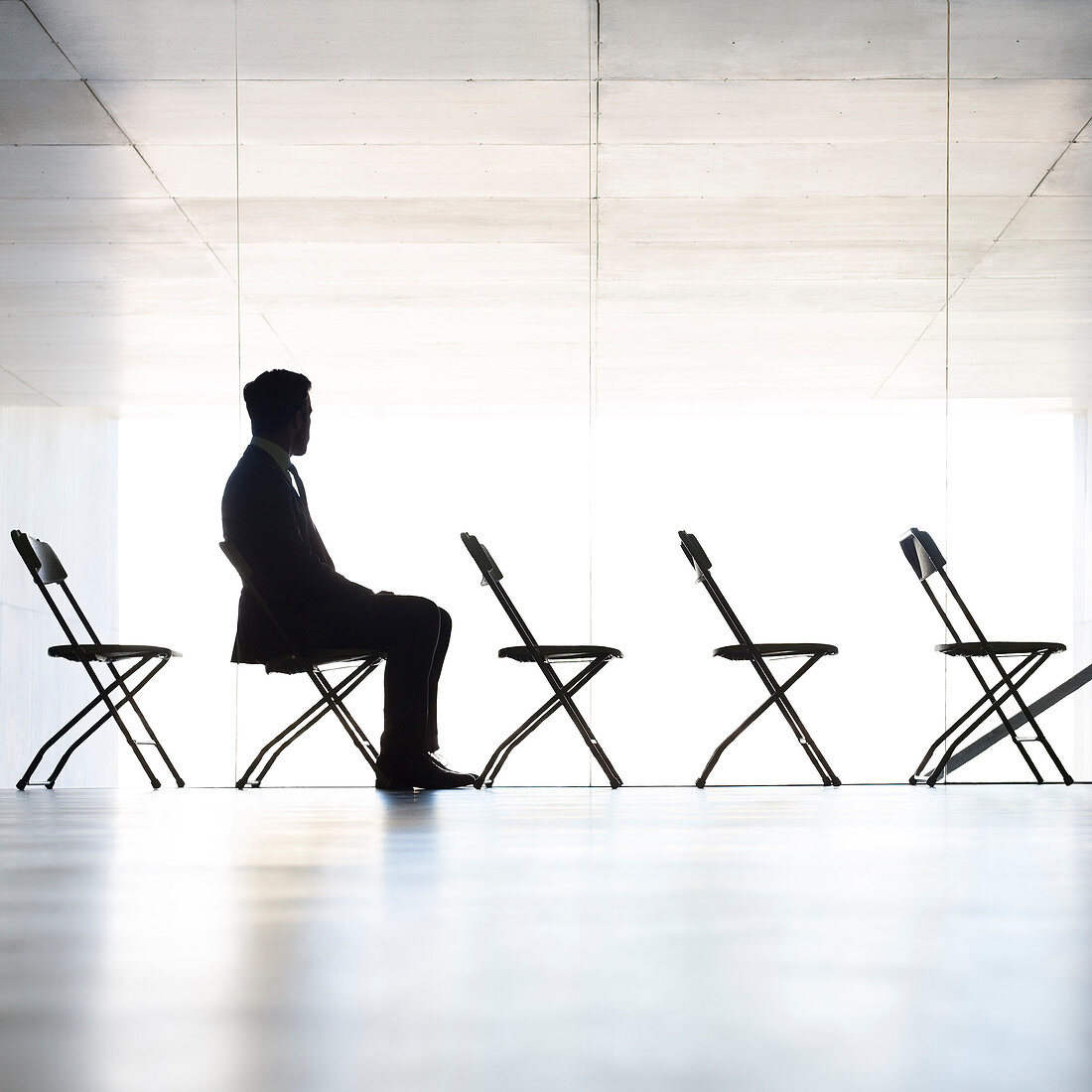 Silhouette of businessman sitting