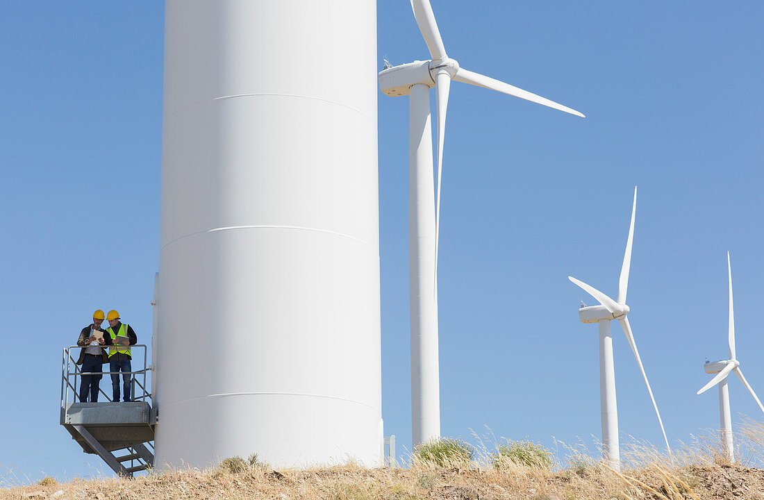 Workers talking on wind turbine