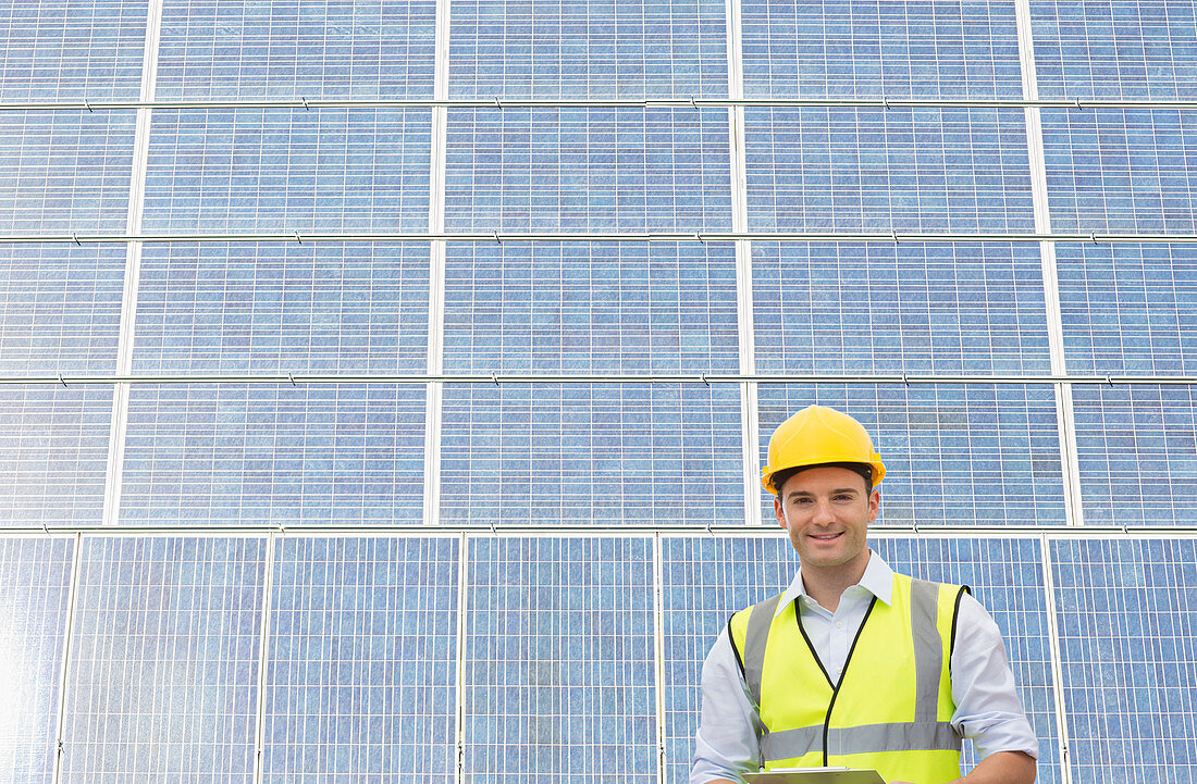 Worker standing by wind turbine