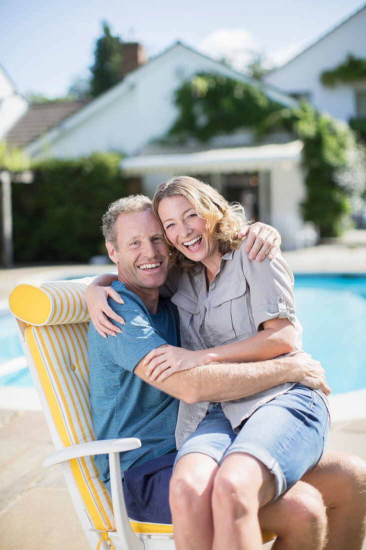 Couple sitting in lounge chair side