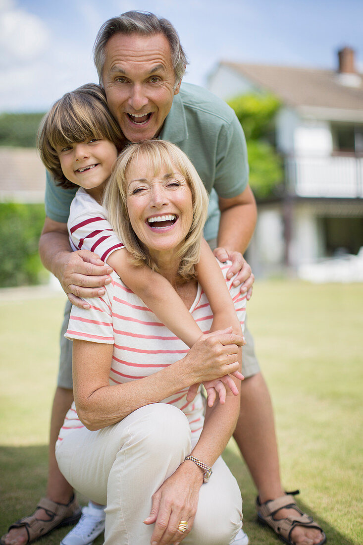 Grandparents and grandson hugging