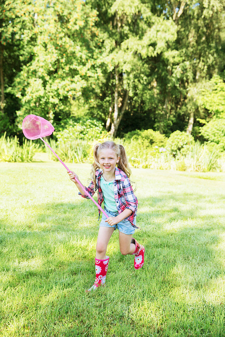 Girl playing with butterfly net