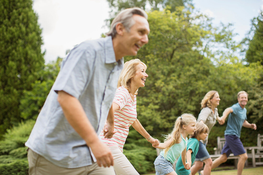 Family holding hands and running