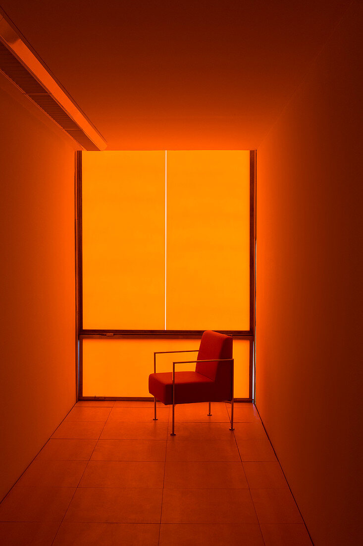 Chair at window in orange office