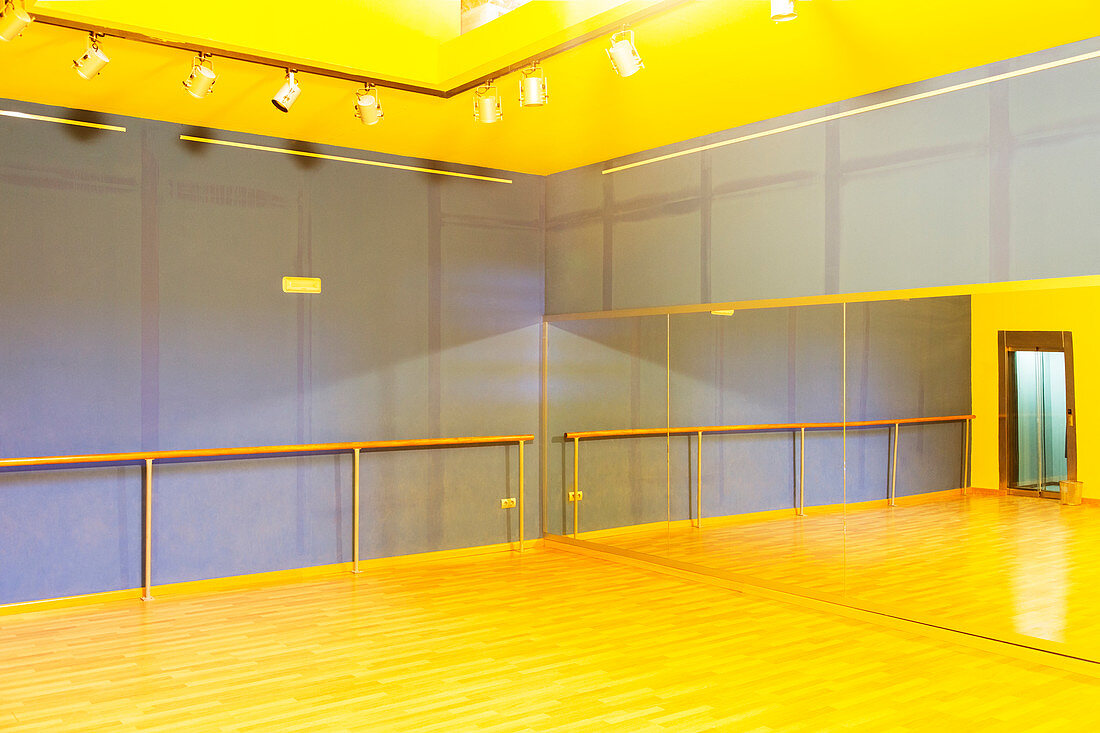 Barre and mirror in empty ballet studio