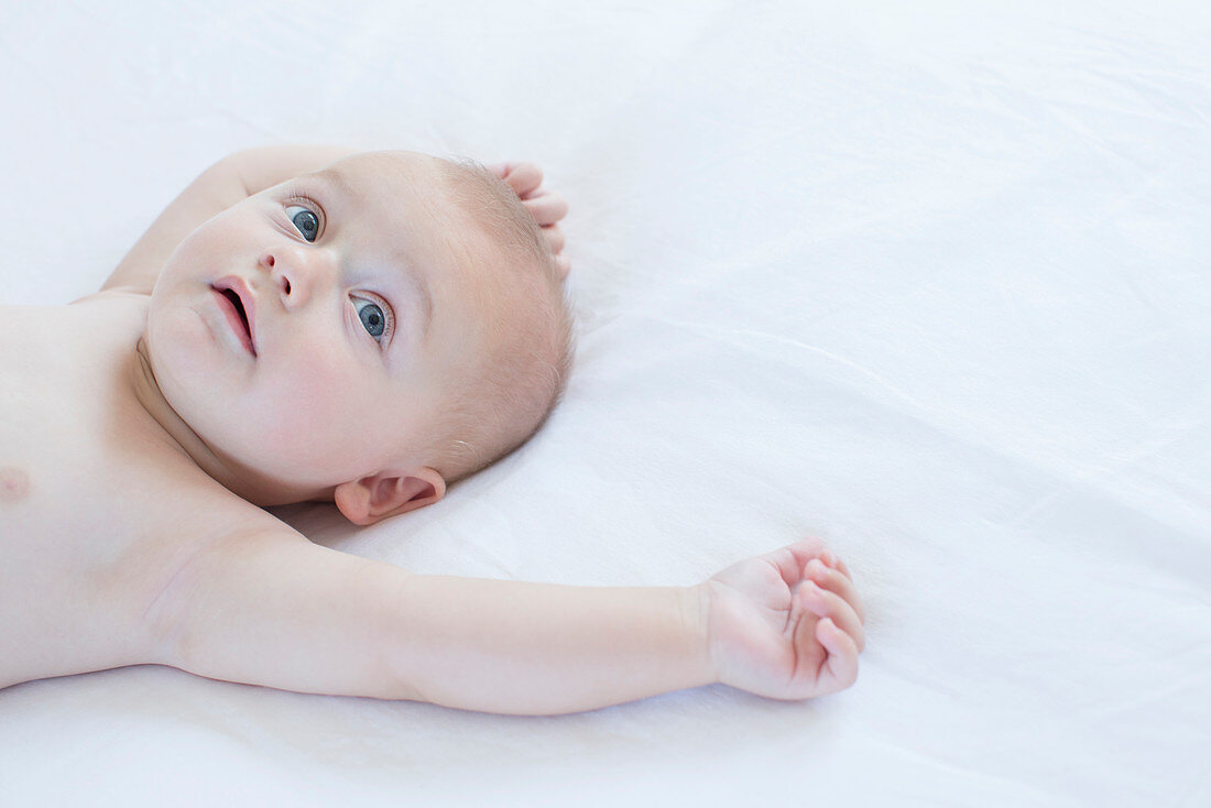 Baby laying on bed