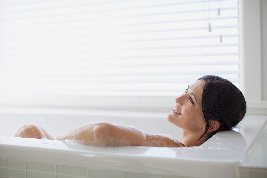 Woman relaxing in bubble bath