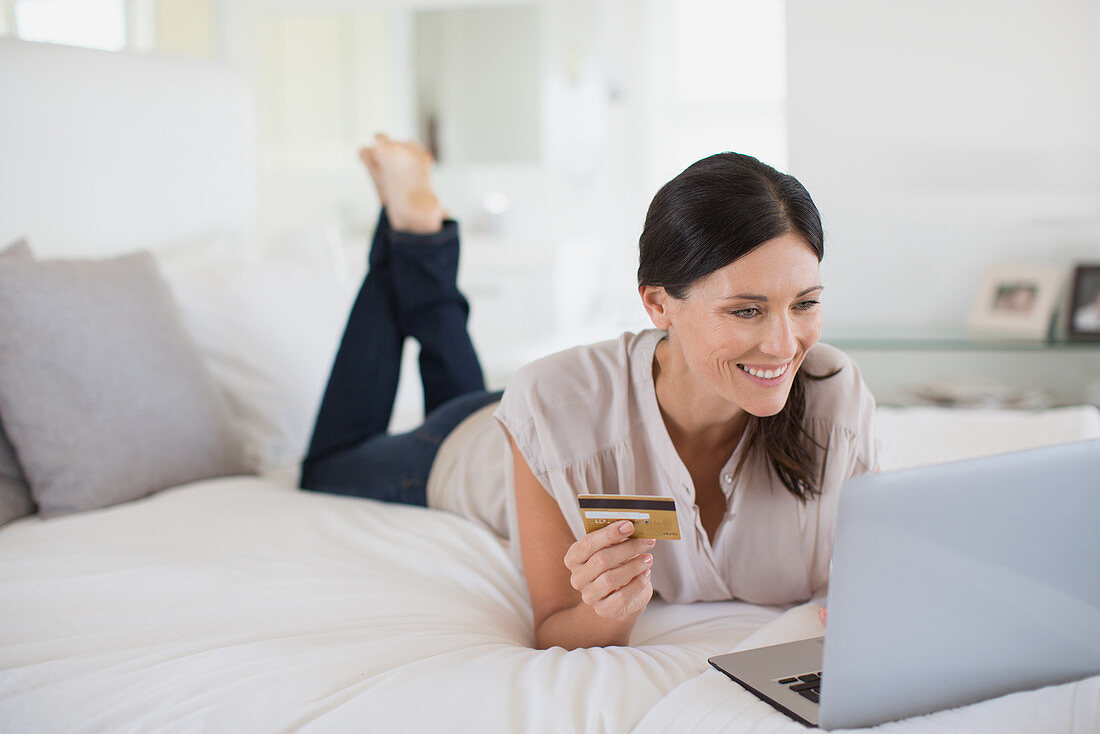Woman shopping online with laptop