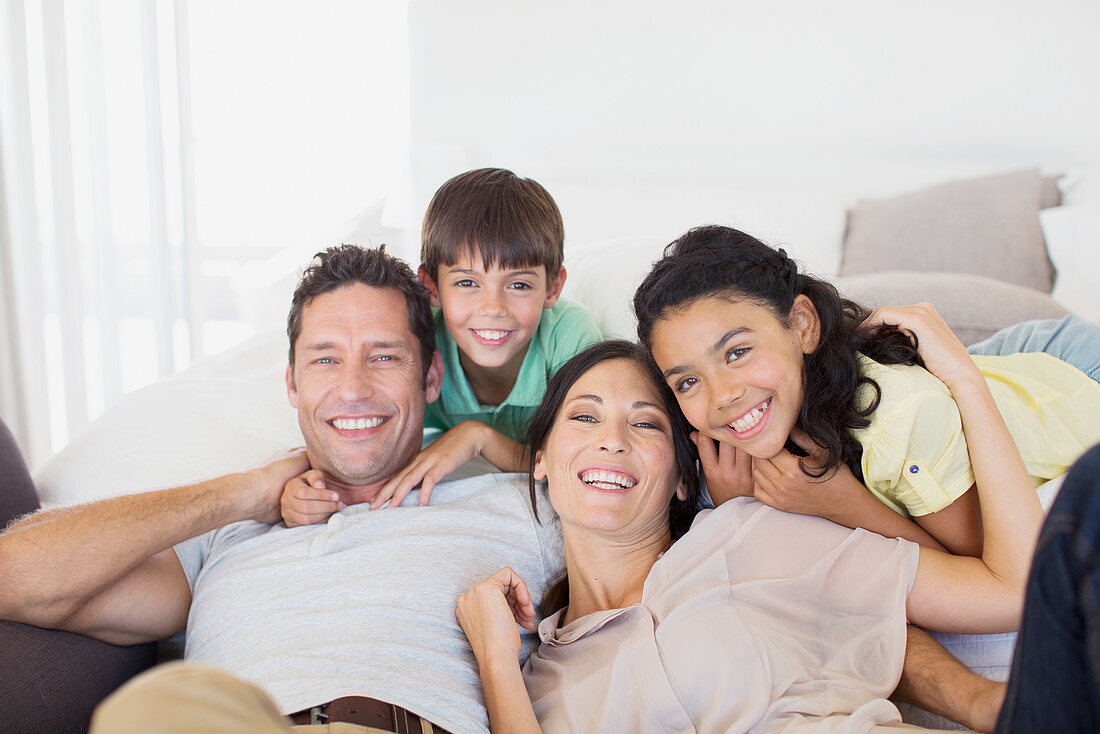 Family smiling together on sofa