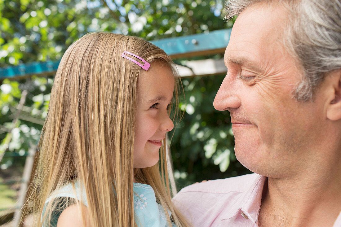 Father holding daughter outdoors