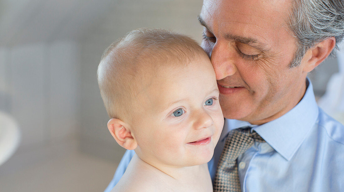 Smiling father holding baby