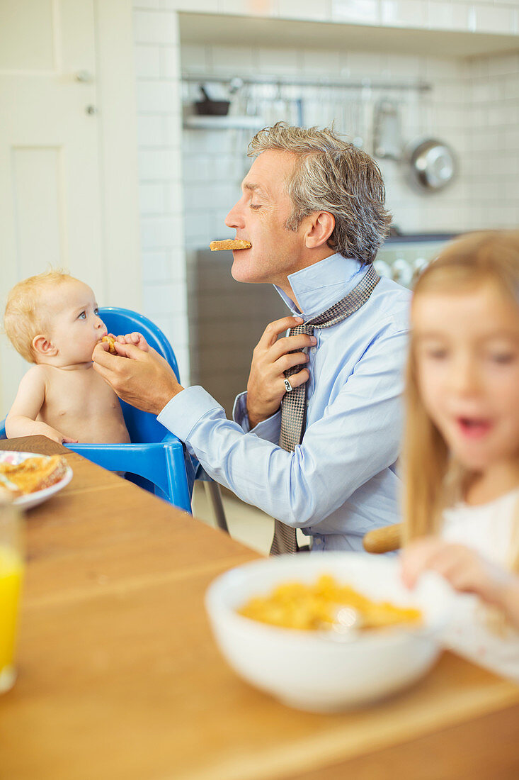 Father and children eating breakfast