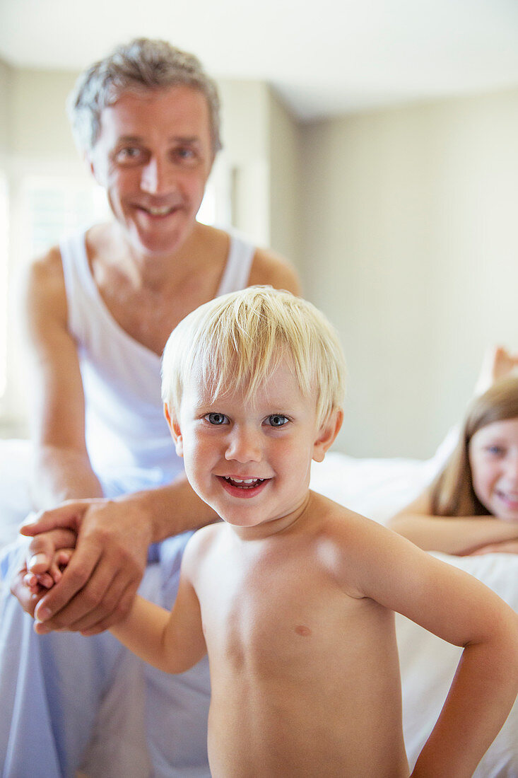 Father and children on bed