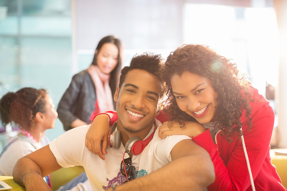 Young couple smiling in student lounge