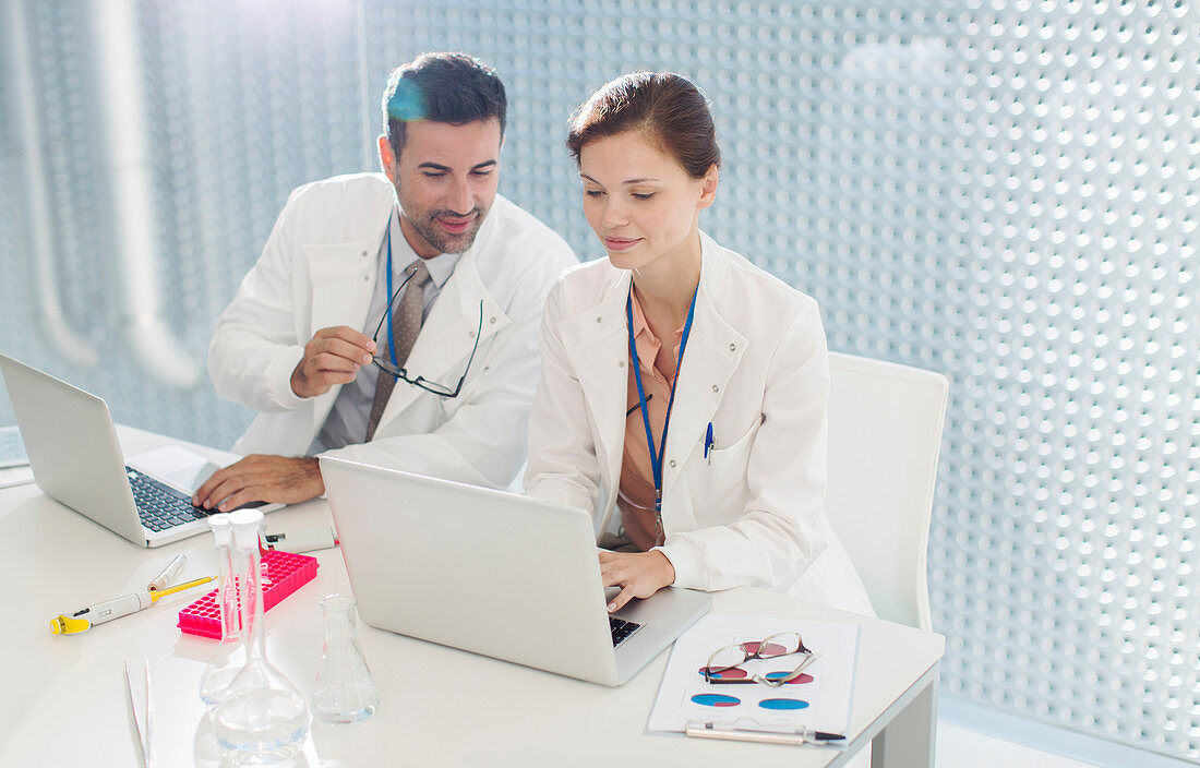 Doctors working at laptop