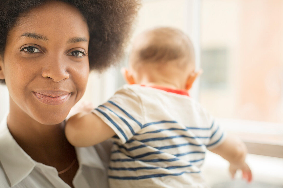 Smiling mother holding baby boy