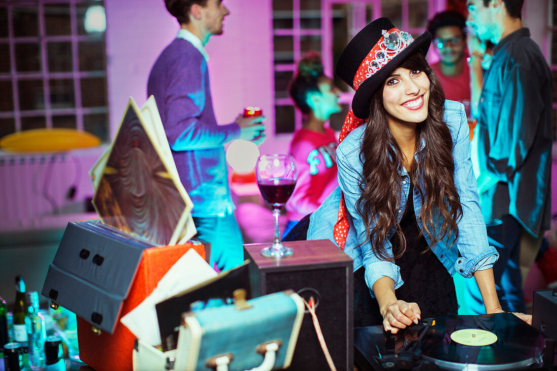 Woman playing records at party