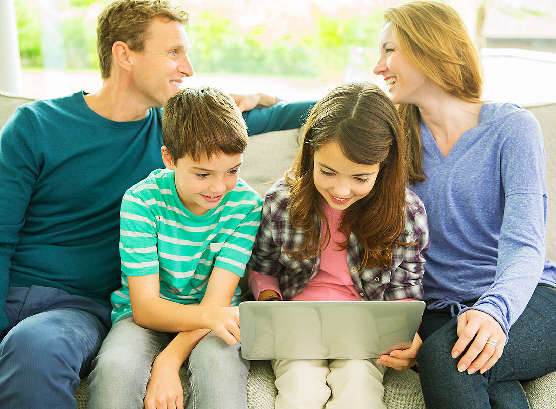 Family relaxing together on sofa