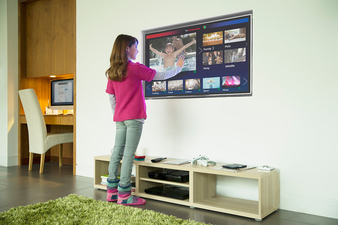 Girl using touch screen television