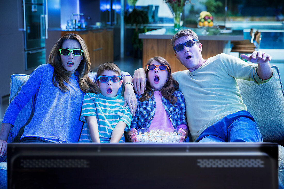 Family watching 3D television