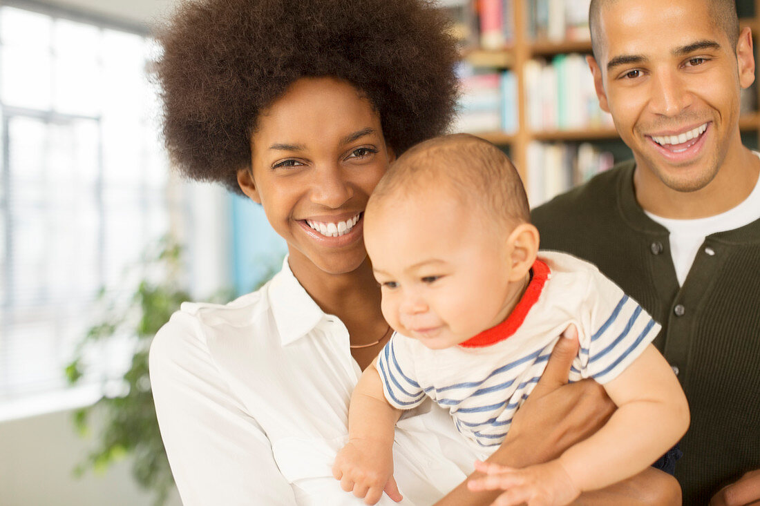 Family smiling together in living room