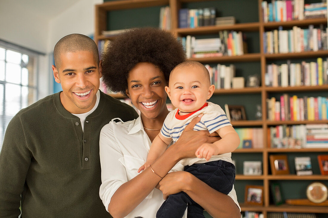 Family smiling together in living room