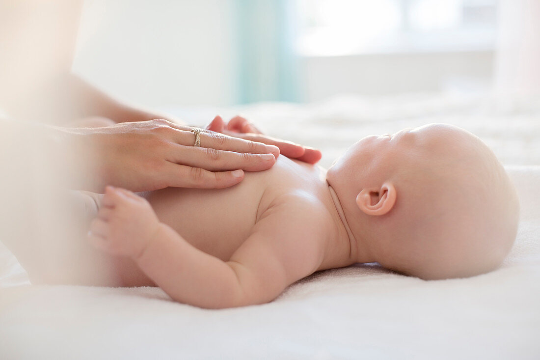 Mother touching baby girl