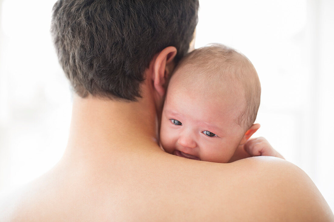 Man comforting crying baby girl