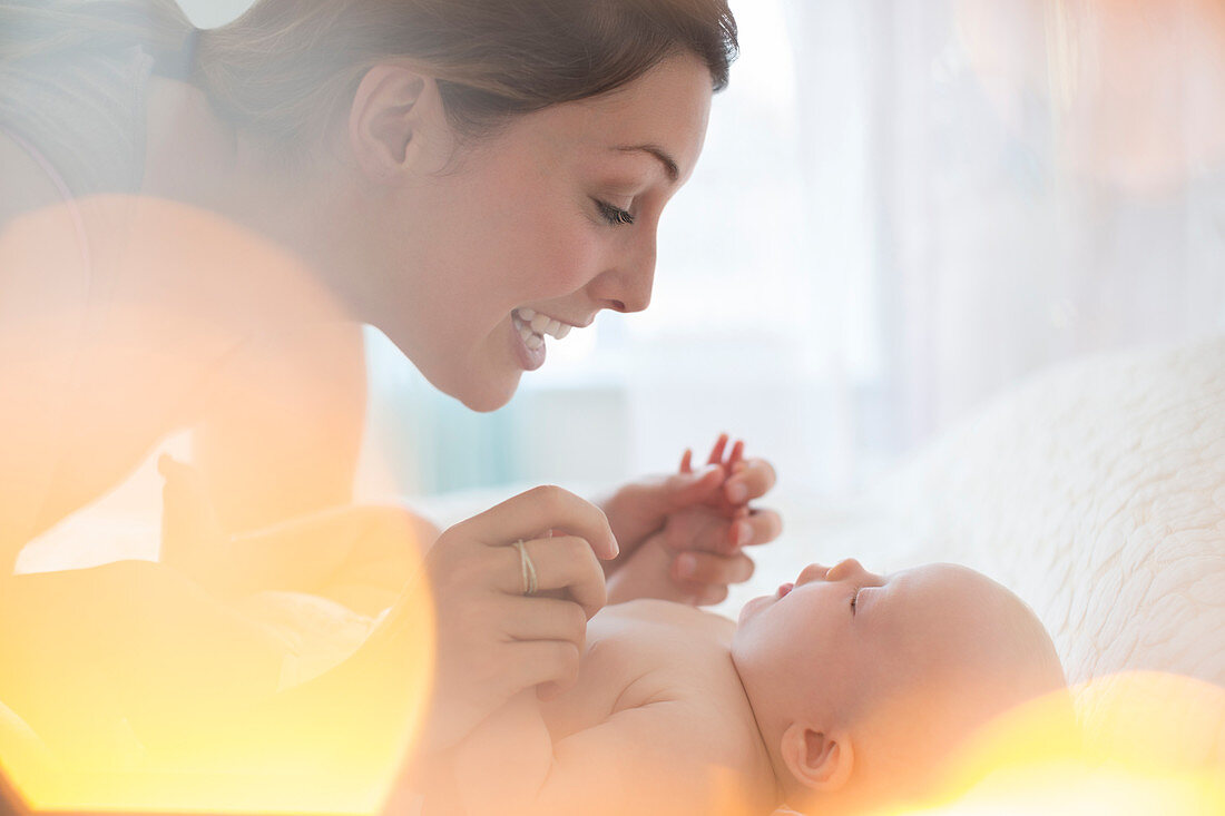 Mother playing with baby girl