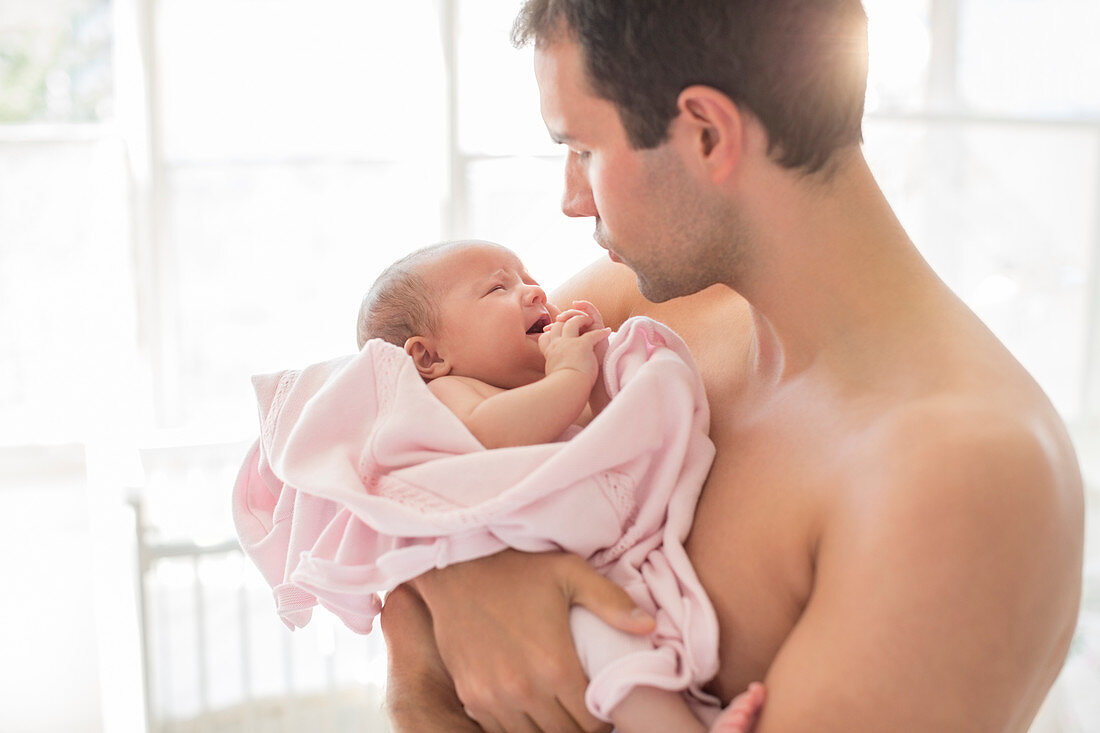 Father holding crying baby girl